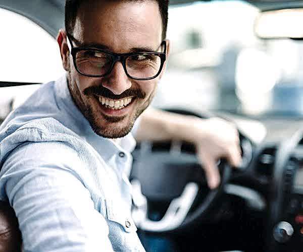 Portrait of a businessman driving car